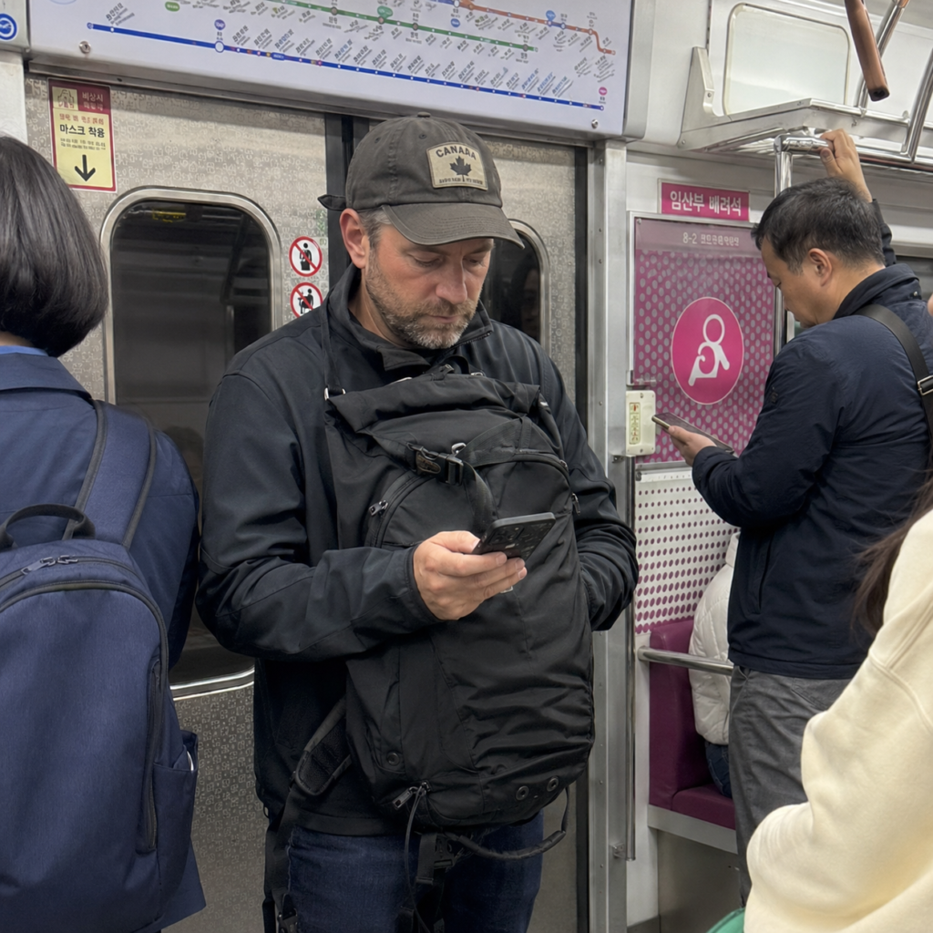 Traveler waits beside subway doors as passengers exit